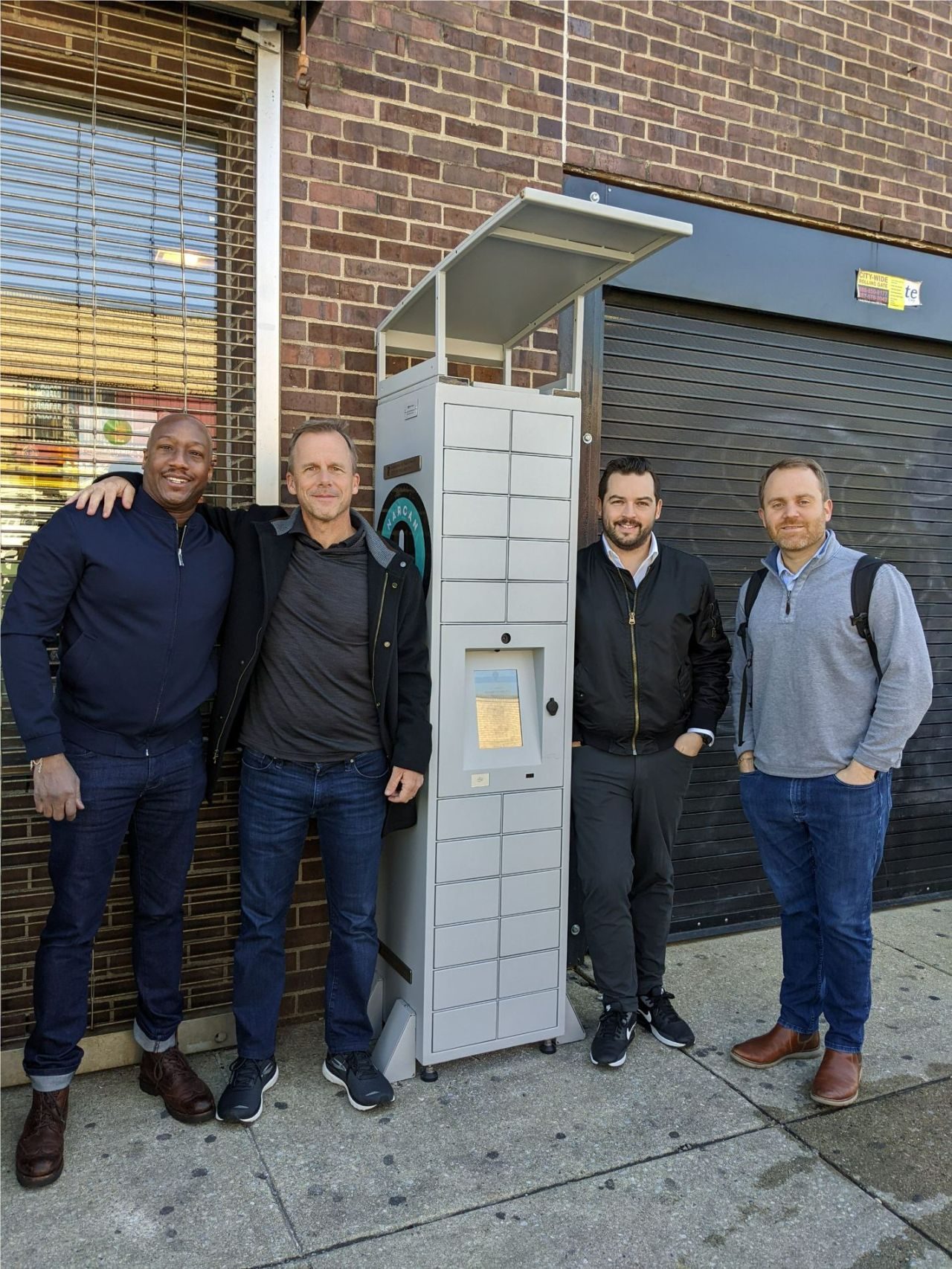 Corey with his team (middle right) and medical advisor, Dr. Ish Major (left) with an early Dispension safer supply system.
